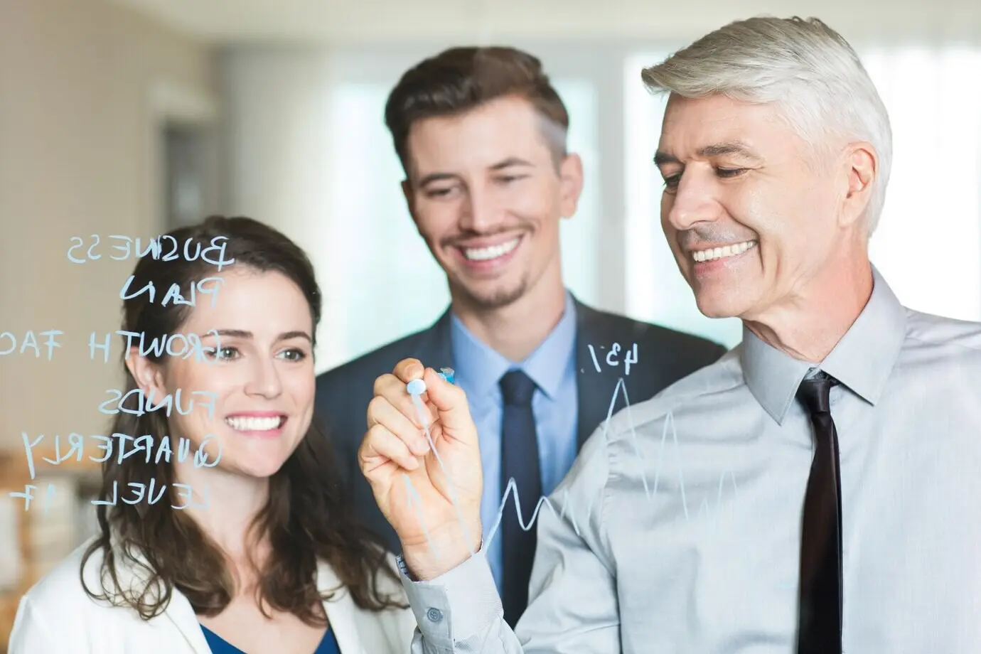 Un jefe feliz dibuja un gráfico y capacita a sus colegas.